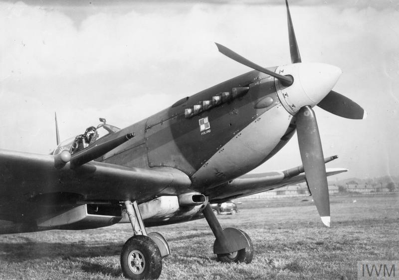 THE POLISH AIR FORCE IN BRITAIN, 1940-1947 (HU 87411) Flight Lieutenant Józef Zulikowski of No. 306 Polish Fighter Squadron in the cockpit of his Spitfire IXC (BS456, UZ-Z) with long-range petrol tank under-slung between the two ducted radiators at RAF Northolt, 16 November 1942. The blanks by the wing cannons are where two further 20mm cannons are fitted when required. Copyright: © IWM. Original Source: http://www.iwm.org.uk/collections/item/object/205094120